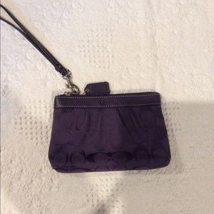 Plum colored coach wristlet