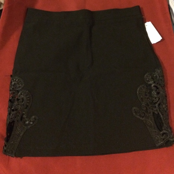 Black mini skirt with lace embroidered sides.