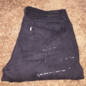 Faded black white paint splattered levis