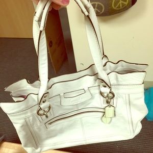 I'm selling a white coach bag that was used once.