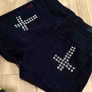 High waist black denim shorts with studded cross detail