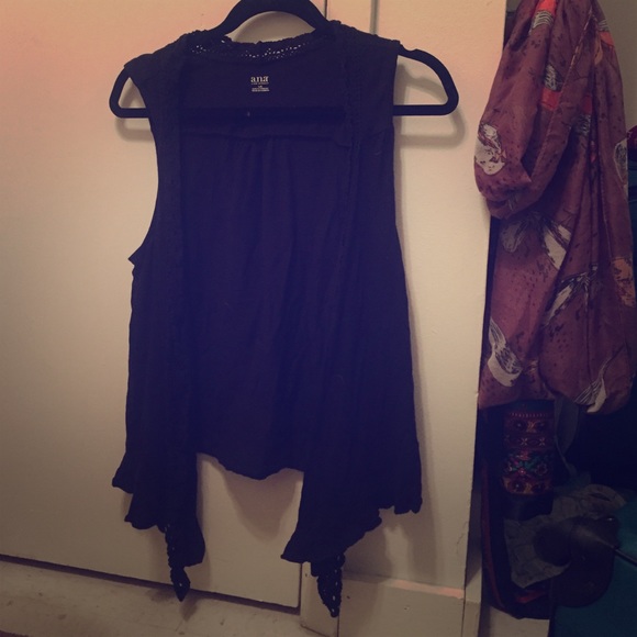 Draped black vest.