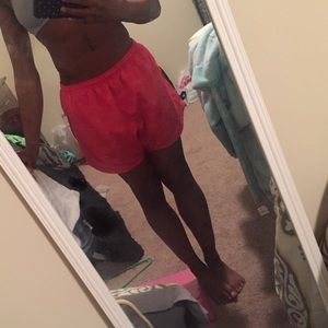 Pink Nike running shorts.