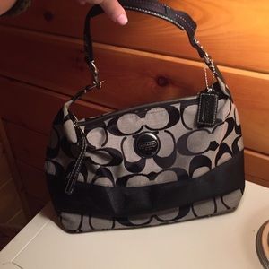 Black bag from Coach with red wallet