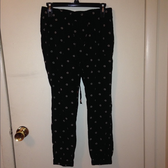 Black joggers with white daisy's.