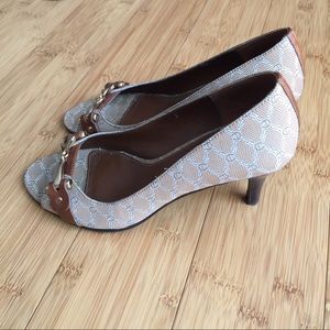 Beige and brown peep-toe pumps with brass hardware