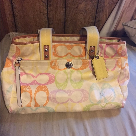 white coach purse with colored c's