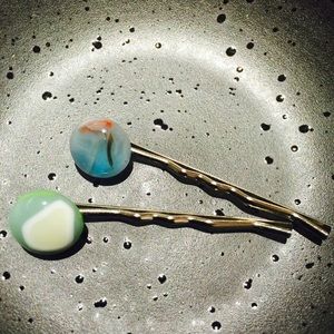A pair of hair clips with colored glaze