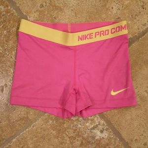 Nike pro combat pink and yellow workout shorts