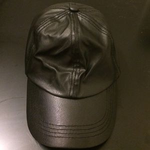 Black faux leather baseball cap. Adjustable strap