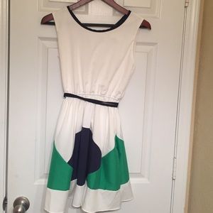 White dress with navy blue trim and belt.
