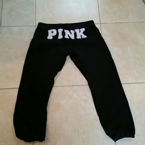 Pink sweatpants with cinching at bottom.