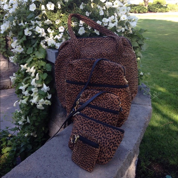 Set of five leopard print corduroy bags.