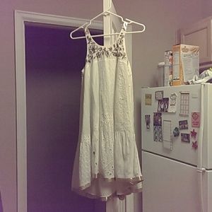 White summer dress with gold trim and decor