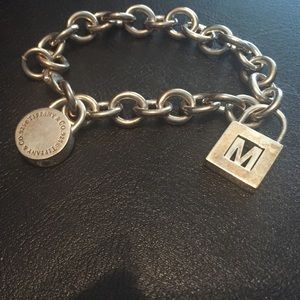 Authentic Tiffany charm bracelet with two charms.