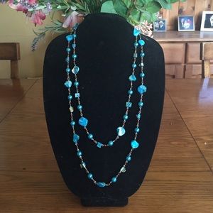 Extra long topaz blue beaded necklace.
