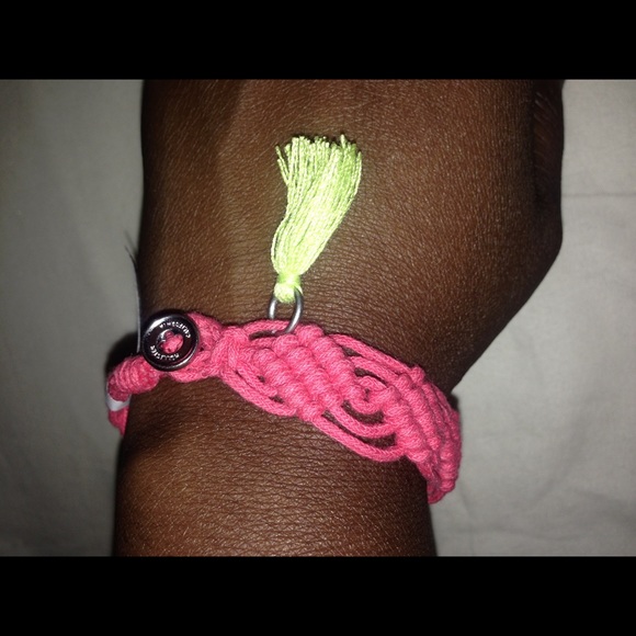 Pink woven soft bracelet with green tassel
