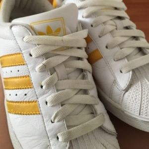 White with yellow adidas superstar