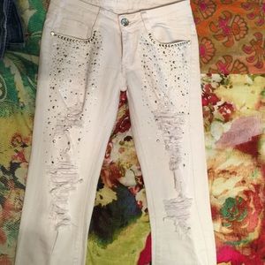 White holey skinny jeans with embellishments