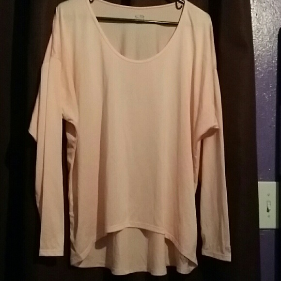 Pale pink work out gear shirt.