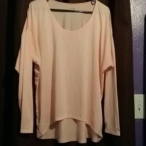 Pale pink work out gear shirt.
