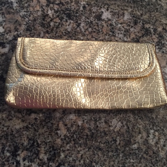 Gold clutch with chain shoulder strap. Like new.
