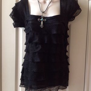 Black knit blouse with ruffles through out