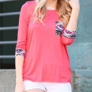 Coral top with Aztec print.