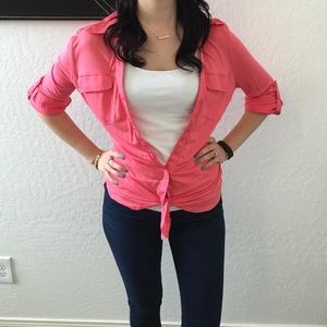 Pink top, with a tie at the bottom