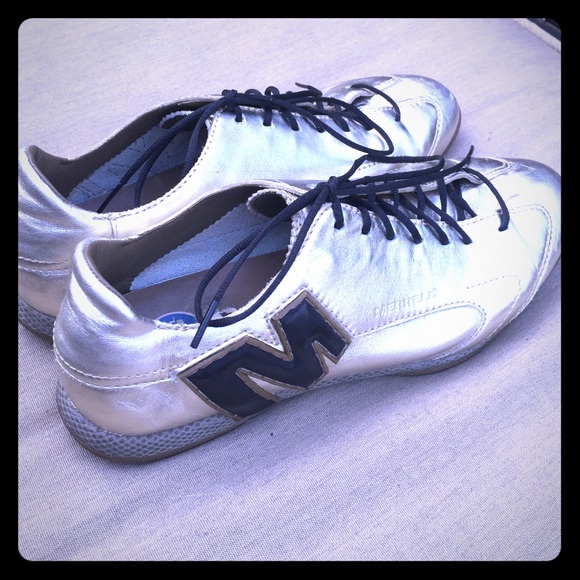 Gold Merrell lace up shoes.