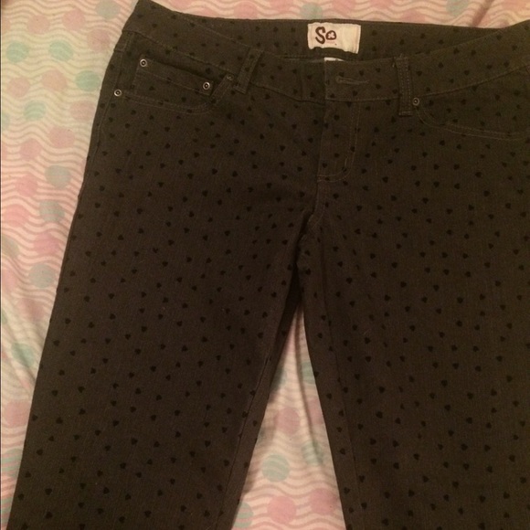 Grey jeans with velvet black hearts.