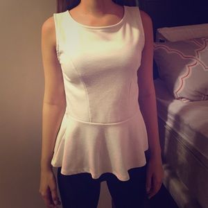 Small white tank top with open back and a bow