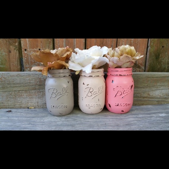 Three elegantly painted mason jars.