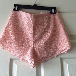 Blush shorts with scalloped hem.