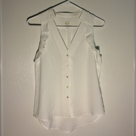 White sleeveless ruffled work shirt