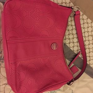 Authentic Coach leather perforated C handbag.