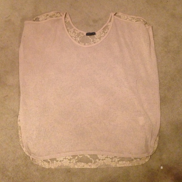 Open-shoulder, laced beige shirt.