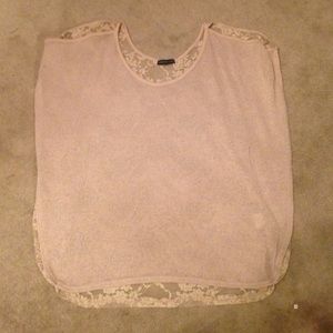 Open-shoulder, laced beige shirt.