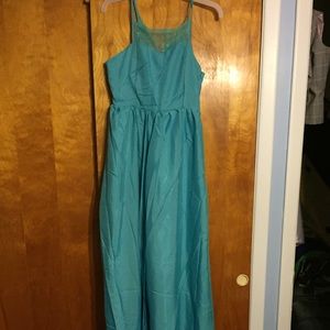 Long teal dress with a slit up to the thigh