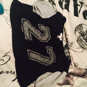 Gray and black thin crop top that has #27