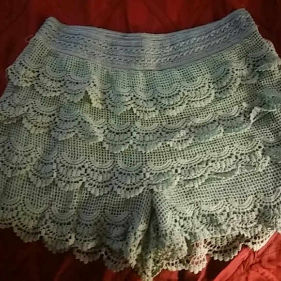 Light turquoise crochet shorts.