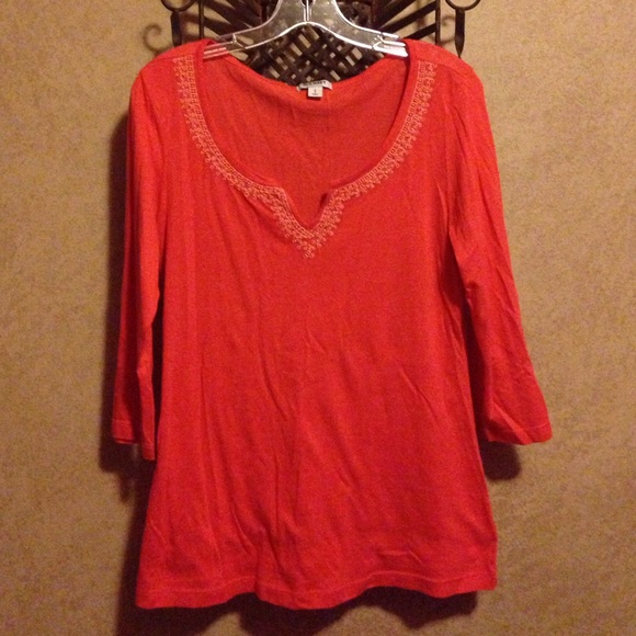 Orange shirt with beads around neck