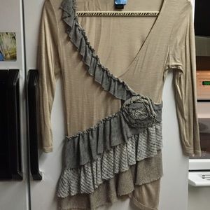 v-neck ruffled gray, tan, and gold shirt.