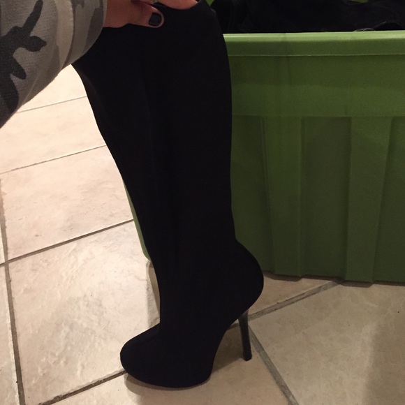 Form fitted, black, knee high boots