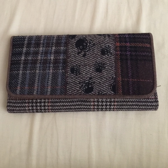 Plaid wallet with skull pattern.
