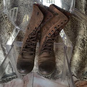 Patinaed brown boots with red zips