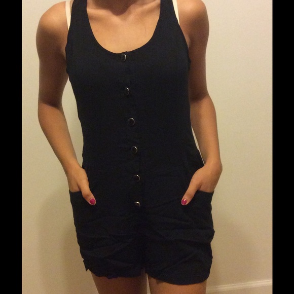 Black short romper with open back.
