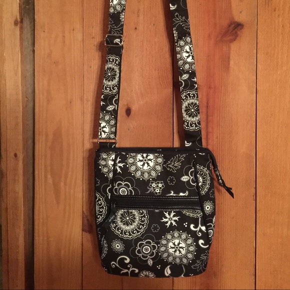 Black and white Thirty One cross body purse .