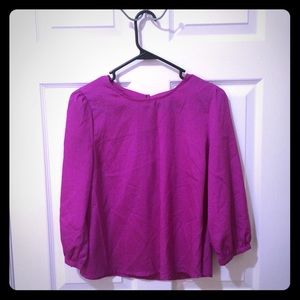 Magenta flowy top with back exposed zip and bow.