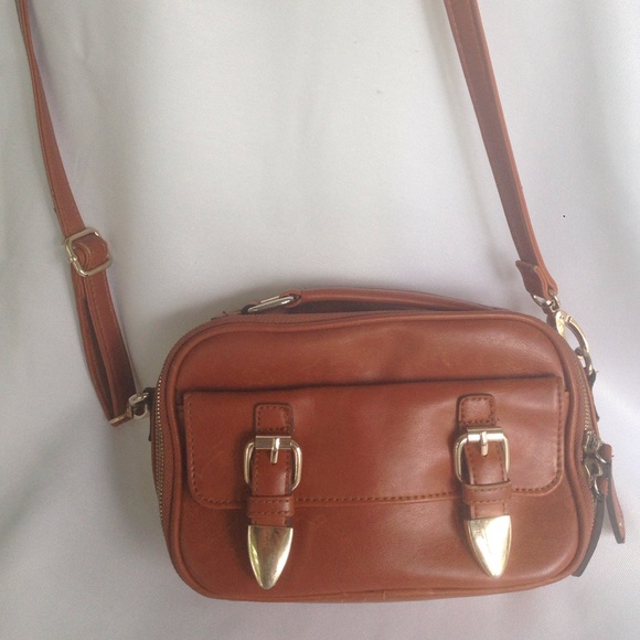 Brown leather tote with gold buckles.